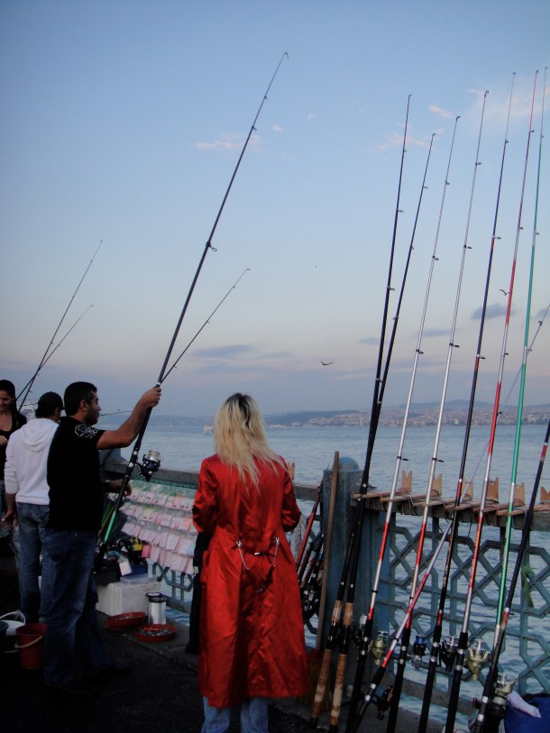 woman-in-red-with-fishermen-istanbul
