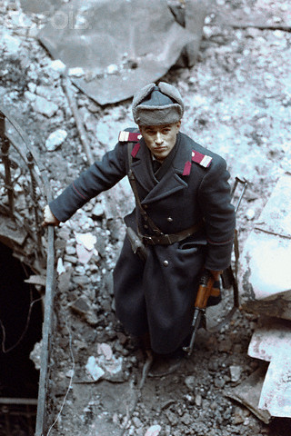 romanian officer standing in rubble