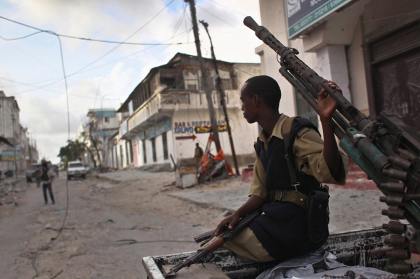 government militiaman sits on a pickup truck-mounted anti-aircraft gun in mogadishus Bakara market